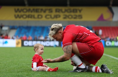 230825 - Wales v Scotland, Women’s Rugby World Cup - Donna Rose of Wales with daughter Margot at the end of the match