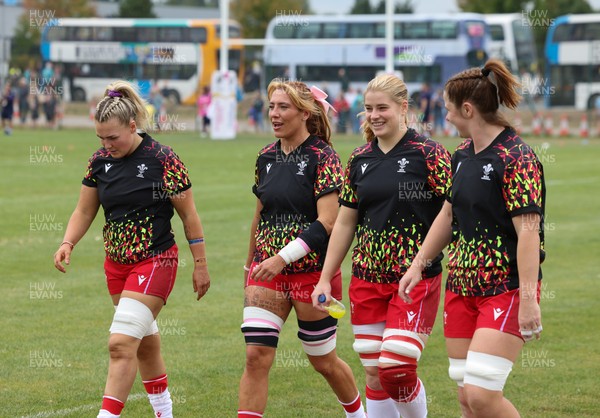 230825 - Wales v Scotland, Women’s Rugby World Cup - Alex Callender of Wales, Georgia Evans of Wales, Bethan Lewis of Wales and Kate Williams of Wales come out for warm up