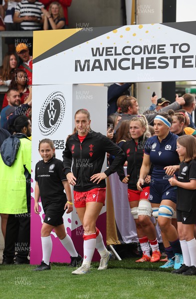 230825 - Wales v Scotland, Women’s Rugby World Cup - Lisa Neumann of Wales leads the team out on her 50th cap