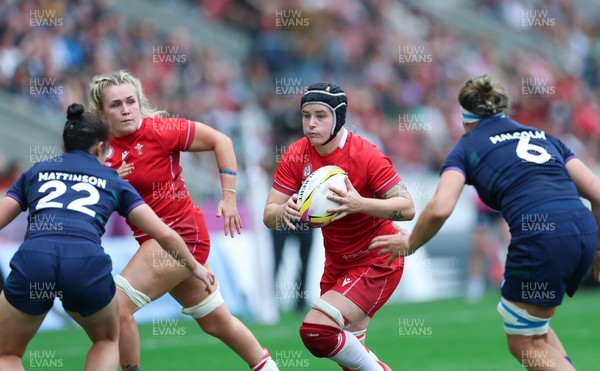 230825 - Wales v Scotland, Women’s Rugby World Cup - Bethan Lewis of Wales takes on Caity Mattinson of Scotland