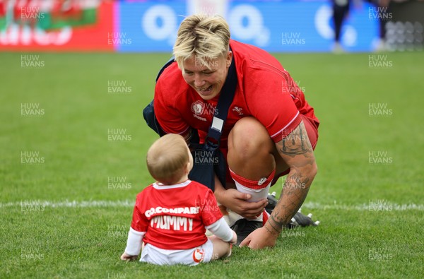 230825 - Wales v Scotland, Women’s Rugby World Cup - Donna Rose of Wales with daughter Margot at the end of the match