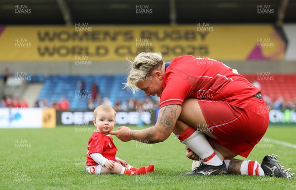 230825 - Wales v Scotland, Women’s Rugby World Cup - Donna Rose of Wales with daughter Margot at the end of the match