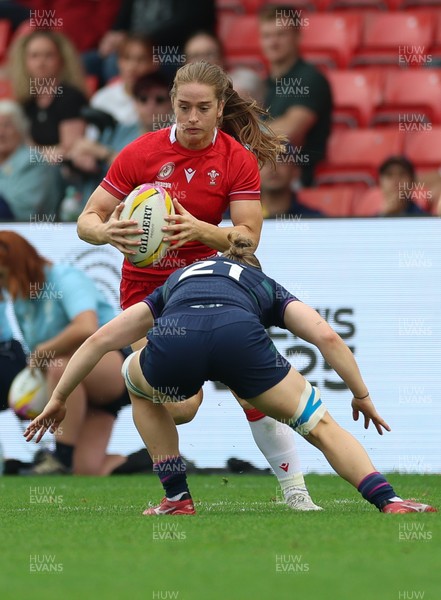 230825 - Wales v Scotland, Women’s Rugby World Cup - Lisa Neumann of Wales takes on Alex Stewart of Scotland