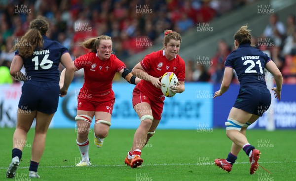 230825 - Wales v Scotland, Women’s Rugby World Cup - Kate Williams of Wales and Abbie Fleming of Wales take on Alex Stewart of Scotland