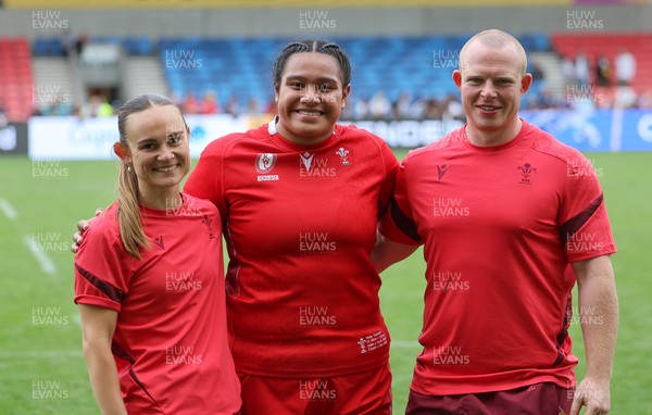 230825 - Wales v Scotland, Women’s Rugby World Cup - Sisilia Tuipulotu of Wales with Cara Jones, physio and Jamie Cox at the end of the match