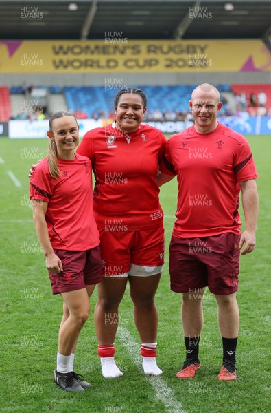 230825 - Wales v Scotland, Women’s Rugby World Cup - Sisilia Tuipulotu of Wales with Cara Jones, physio and Jamie Cox at the end of the match