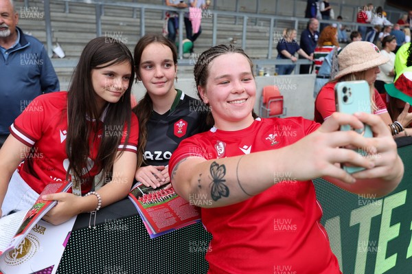 230825 - Wales v Scotland, Women’s Rugby World Cup - Maisie Davies of Wales with fans