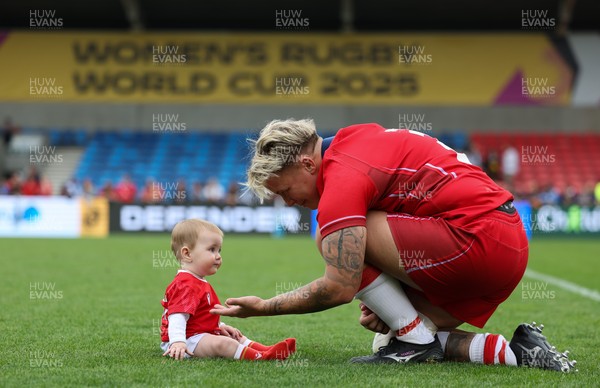 230825 - Wales v Scotland, Women’s Rugby World Cup - Donna Rose of Wales with daughter Margot at the end of the match