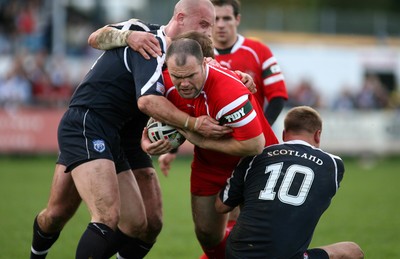 29.10.06...Wales v Scotland Rugby League, Bridgend. Wales' Gareth Price is held by Neil Lowe and Spencer Miller 