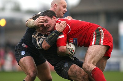 29.10.06...Wales v Scotland Rugby League, Bridgend. Wales' Robert Roberts is stopped by Spencer Miller and Paul Jackson 