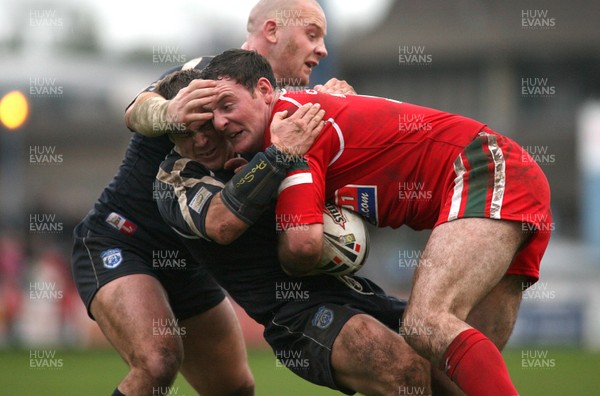 29.10.06...Wales v Scotland Rugby League, Bridgend. Wales' Robert Roberts is stopped by Spencer Miller and Paul Jackson 