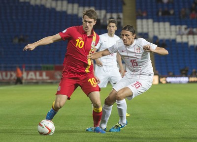 100913 -  Wales v Serbia - FIFA 2014 World Cup Qualifying Match -   Aaron Ramsey of Wales, left, is tackled by Ljubomir Fejsa of Serbia( c ) Huw Evans Agency