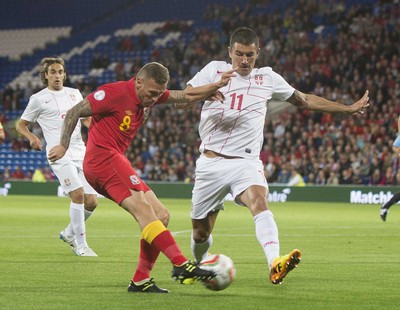 100913 -  Wales v Serbia - FIFA 2014 World Cup Qualifying Match -  Craig Bellamy of Wales, left, is tackled by Aleksandar Kolarov of Serbia( c ) Huw Evans Agency