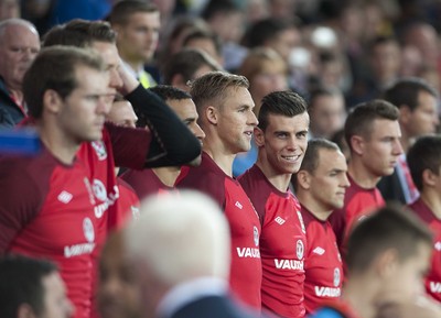 100913 -  Wales v Serbia - FIFA 2014 World Cup Qualifying Match -  Gareth Bale of Wales smiles as he takes his piace on the subs bench( c ) Huw Evans Agency