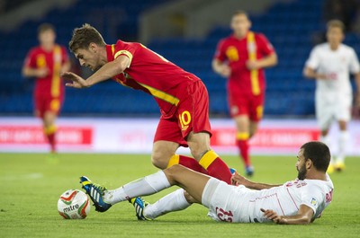 100913 -  Wales v Serbia - FIFA 2014 World Cup Qualifying Match -  Aaropn Ramsey of Wales is tackled by Ivan Radovanovic of Serbia( c ) Huw Evans Agency