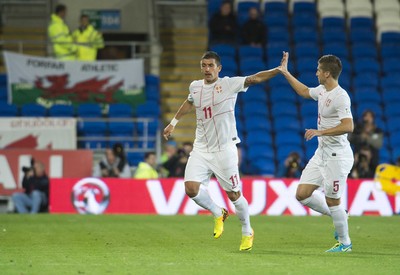 100913 -  Wales v Serbia - FIFA 2014 World Cup Qualifying Match -  Aleksandar Kolarov of Serbia, left, celebrates scoring a goal( c ) Huw Evans Agency