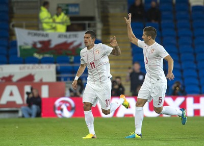 100913 -  Wales v Serbia - FIFA 2014 World Cup Qualifying Match -  Aleksandar Kolarov of Serbia, left, celebrates scoring a goal( c ) Huw Evans Agency