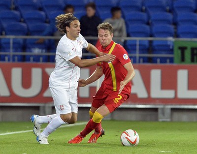 100913 -  Wales v Serbia - FIFA 2014 World Cup Qualifying Match -  Chris Gunter of Wales, right, is beaten to the ball by Lazar Markovic of Serbia( c ) Huw Evans Agency