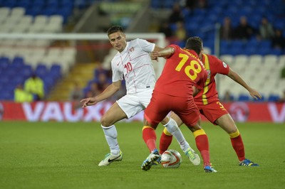 100913 -  Wales v Serbia - FIFA 2014 World Cup Qualifying Match -  Dusan Tadic of Serbia is tackled by Hal Robson Kanu and Craig Bellamy of Wales( c ) Huw Evans Agency