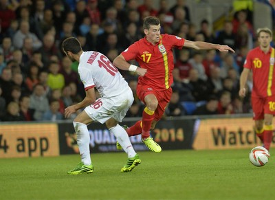 100913 -  Wales v Serbia - FIFA 2014 World Cup Qualifying Match -  Gareth Bale of Wales beats the challenge by Luka Milivojevic of Serbia( c ) Huw Evans Agency