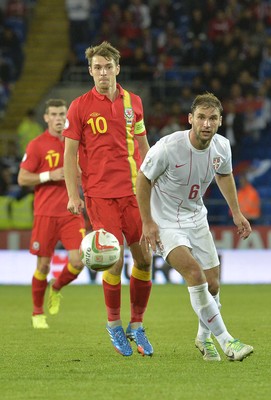 100913 -  Wales v Serbia - FIFA 2014 World Cup Qualifying Match -  Aaron Ramsey of Wales and Branslav Ivanovic of Serbia watch the ball( c ) Huw Evans Agency