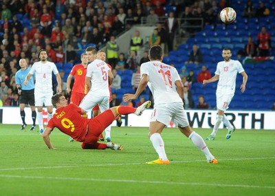 100913 -  Wales v Serbia - FIFA 2014 World Cup Qualifying Match -   Sam Vokes of Wales heads the ball at goal( c ) Huw Evans Agency