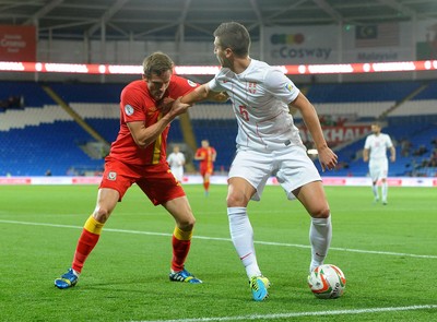 100913 -  Wales v Serbia - FIFA 2014 World Cup Qualifying Match -  Andy King of Wales, left, is held off by Matija Nastasic of Serbia( c ) Huw Evans Agency