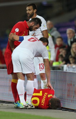 100913 - Wales v Serbia, FIFA 2014 World Cup Qualifying - Wales' Aaron Ramsey lies injured after colliding with the advertising displays- (c) Huw Evans Picture Agency, Cardiff