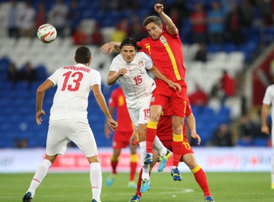 100913 - Wales v Serbia, FIFA 2014 World Cup Qualifying - Wales' Andy King and Serbia's Ljubomir Fejsa compete for the ball- (c) Huw Evans Picture Agency, Cardiff