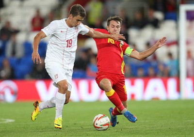 100913 - Wales v Serbia, FIFA 2014 World Cup Qualifying - Wales' Aaron Ramsey challenges Serbia's Filip Duricic- (c) Huw Evans Picture Agency, Cardiff