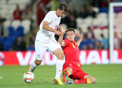 100913 - Wales v Serbia, FIFA 2014 World Cup Qualifying - Wales' Aaron Ramsey challenges Serbia's Filip Duricic- (c) Huw Evans Picture Agency, Cardiff