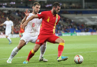 100913 - Wales v Serbia, FIFA 2014 World Cup Qualifying - Wales' Joe Ledley holds off Serbia's Branslav Ivanovic- (c) Huw Evans Picture Agency, Cardiff
