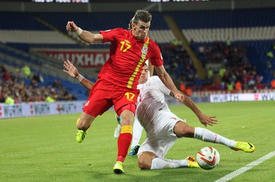 100913 - Wales v Serbia, FIFA 2014 World Cup Qualifying - Wales' Gareth Bale is challenged by Serbia's Aleksandar Kolarov- (c) Huw Evans Picture Agency, Cardiff