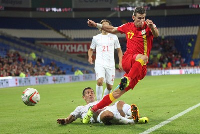 100913 - Wales v Serbia, FIFA 2014 World Cup Qualifying - Wales' Gareth Bale is challenged by Serbia's Aleksandar Kolarov- (c) Huw Evans Picture Agency, Cardiff