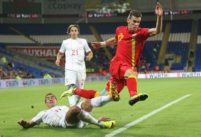 100913 - Wales v Serbia, FIFA 2014 World Cup Qualifying - Wales' Gareth Bale is challenged by Serbia's Aleksandar Kolarov- (c) Huw Evans Picture Agency, Cardiff
