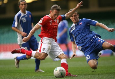 07.10.06...Wales v Slovakia, Euro 2008 Qualifying Match, Cardiff Wales' Craig Bellamy fires shot at goal as Jan Durica closes in 