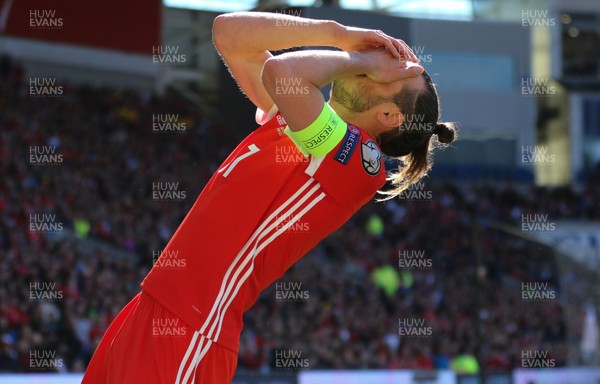 240319 - Wales v Slovakia, UEFA Euro 2020 Qualifier - Gareth Bale of Wales reacts and holds his face after being struck during a challenge