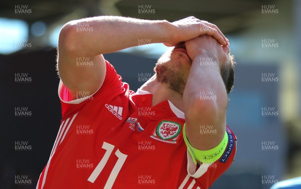 240319 - Wales v Slovakia, UEFA Euro 2020 Qualifier - Gareth Bale of Wales reacts and holds his face after being struck during a challenge