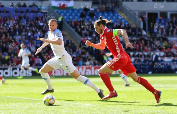 240319 - Wales v Slovakia, UEFA Euro 2020 Qualifier - Gareth Bale of Wales breaks past Denis Varro of Slovakia