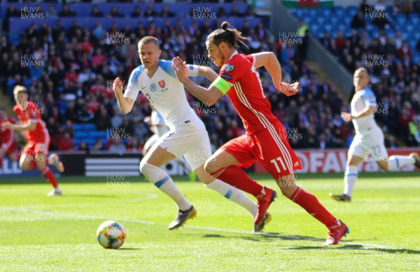 240319 - Wales v Slovakia, UEFA Euro 2020 Qualifier - Gareth Bale of Wales breaks past Denis Varro of Slovakia