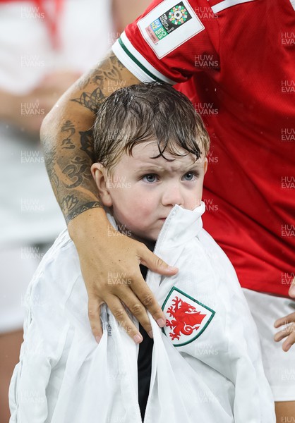 060922 - Wales v Slovenia, FIFA Women's World Cup 2023 Qualifier - A young mascot is sheltered from the rain before the start of the match