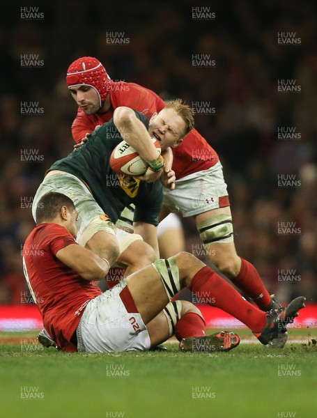 021217 - Wales v South Africa, 2017 Under Armour Autumn Series - Dan du Preez of South Africa is tackled by Cory Hill of Wales and Taulupe Faletau of Wales