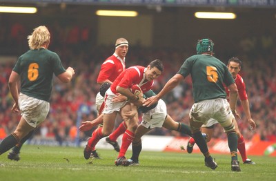06.11.04 Wales v S.Africa,Cardiff  Wales Stephen Jones is tackled by Joe Van Niekerk  Huw Evans,Cardiff