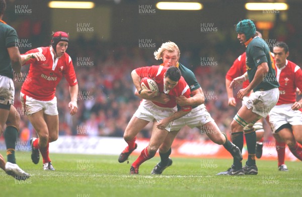 06.11.04 Wales v S.Africa,Cardiff  Wales Stephen Jones is tackled by Schalk Burger  Huw Evans,Cardiff