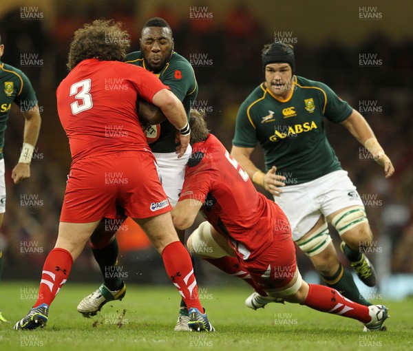 091113  - Wales v South Africa - 2013 Dove Men Series - Tendai Mtawarira of South Africa is tackled by Adam Jones and Alun Wyn Jones of Wales 