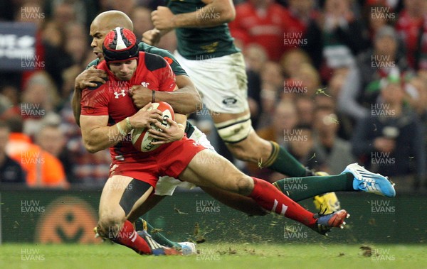 091113 - Wales v South Africa, Dove Mens Autumn Series - Wales' Leigh Halfpenny is tackled by South Africa's JP Pietersen