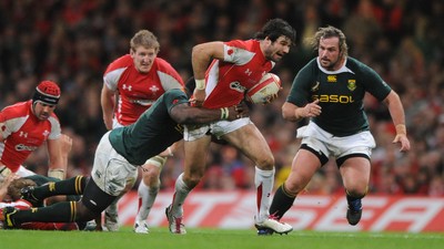 13.11.10 - Wales v South Africa - Invesco Perpetual Series 2010 - Mike Phillips of Wales is tackled by Tendai Mtawarira of South Africa. 