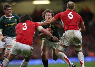 13.11.10 .. Wales v South Africa. -  South Africa's Francois Steyn is stopped by Wales' Andy Powell and Adam Jones  