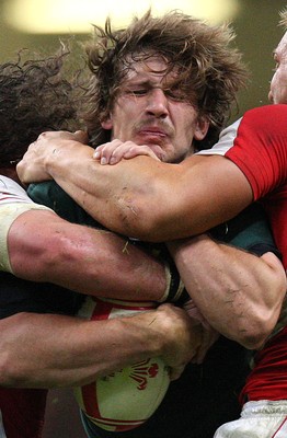 13.11.10 .. Wales v South Africa. -  South Africa's Francois Steyn is stopped by Wales' Andy Powell and Adam Jones  