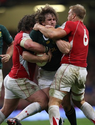 13.11.10 .. Wales v South Africa. -  South Africa's Francois Steyn is stopped by Wales' Andy Powell and Adam Jones  